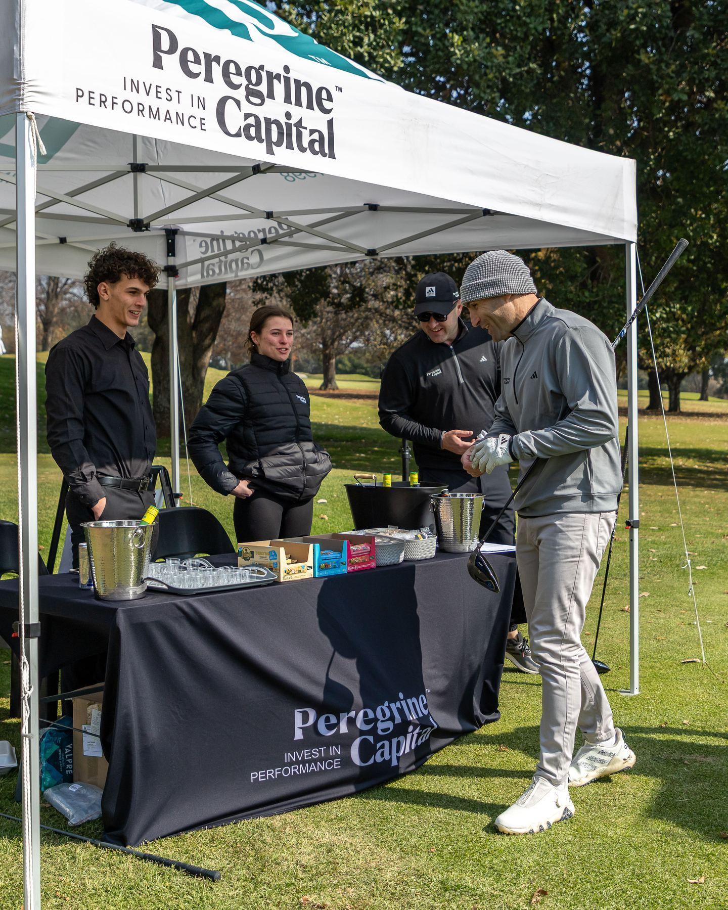 StuSta staff serving golfers at a sponsor stand